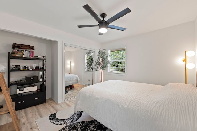bedroom featuring light wood-style floors, a closet, a ceiling fan, and baseboards