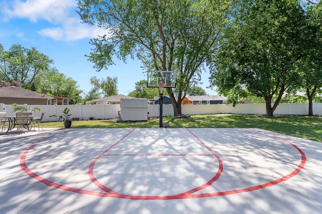 view of basketball court with a shed and basketball court