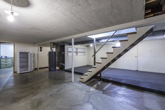 916 Wilson Ct, Zion, IL 60099 - finished basement with stairs, water heater, and a textured ceiling