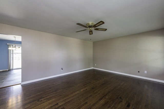 916 Wilson Ct, Zion, IL 60099 - spare room featuring a chandelier, ceiling fan, and dark wood finished floors