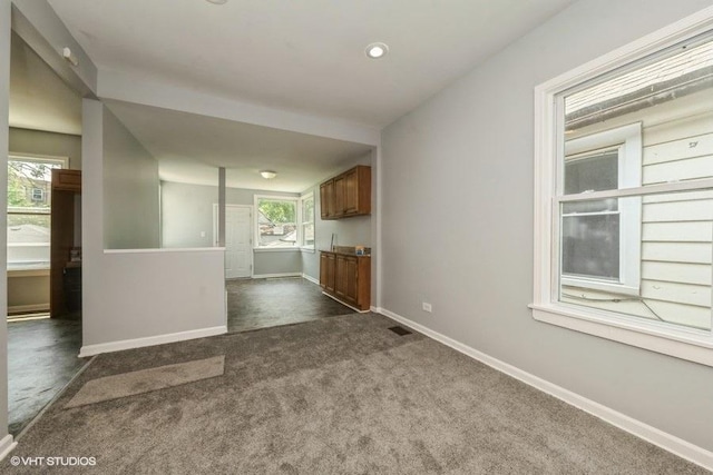1505 E 76th Pl, Chicago, IL 60619 - unfurnished living room featuring dark colored carpet and recessed lighting