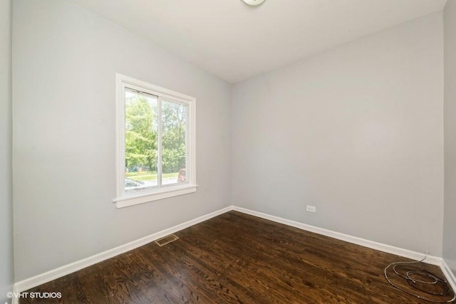 1505 E 76th Pl, Chicago, IL 60619 - spare room with baseboards and dark wood-style flooring