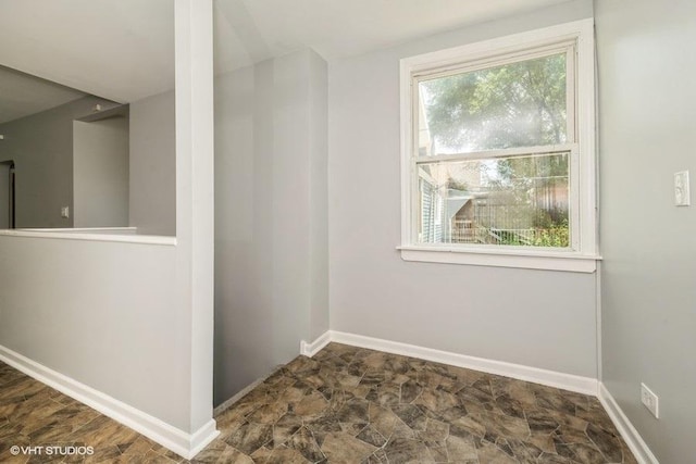 1505 E 76th Pl, Chicago, IL 60619 - spare room featuring baseboards and stone finish floors
