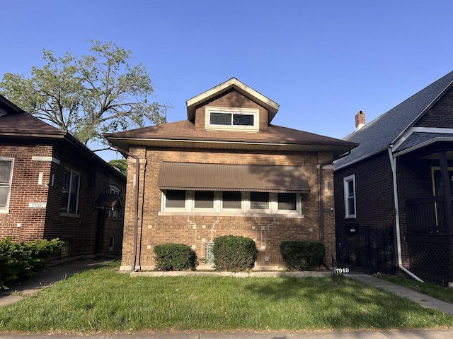 7949 S Manistee Ave, Chicago, IL 60617 - bungalow-style house with brick siding and a front yard