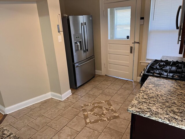 7949 S Manistee Ave, Chicago, IL 60617 - kitchen featuring stainless steel refrigerator with ice dispenser, baseboards, and black range with gas stovetop