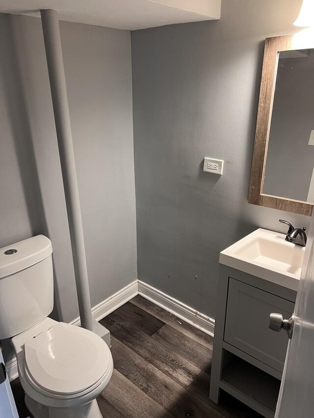 7949 S Manistee Ave, Chicago, IL 60617 - bathroom with wood finished floors, vanity, toilet, and baseboards