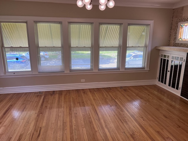 7949 S Manistee Ave, Chicago, IL 60617 - unfurnished dining area with ornamental molding, a chandelier, wood finished floors, and baseboards