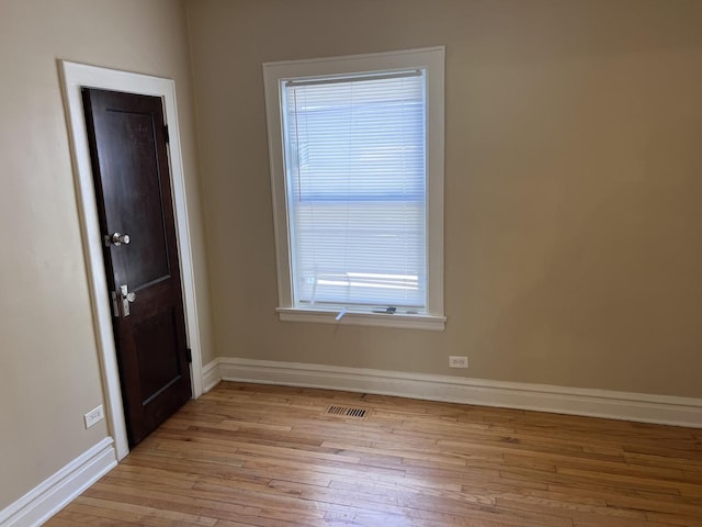 7949 S Manistee Ave, Chicago, IL 60617 - unfurnished room featuring light wood-style floors, healthy amount of natural light, and baseboards