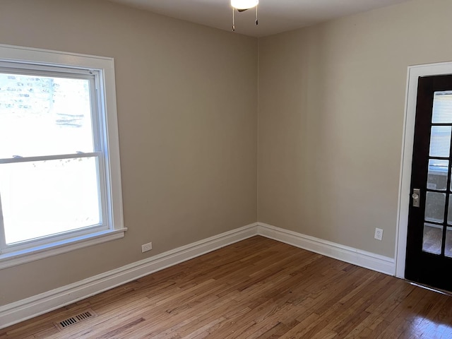 7949 S Manistee Ave, Chicago, IL 60617 - spare room with wood finished floors, plenty of natural light, baseboards, and ceiling fan
