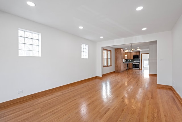 2934 Maple Ave, Berwyn, IL 60402 - unfurnished living room with a chandelier, light wood-style flooring, baseboards, and recessed lighting