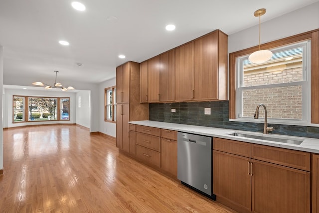 2934 Maple Ave, Berwyn, IL 60402 - kitchen featuring stainless steel dishwasher, a sink, a chandelier, brown cabinets, and decorative backsplash