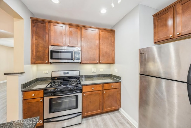 50 Forest Ave Unit 3S, Riverside, IL 60546 - kitchen with stainless steel appliances, light wood-style floors, dark stone countertops, baseboards, and recessed lighting