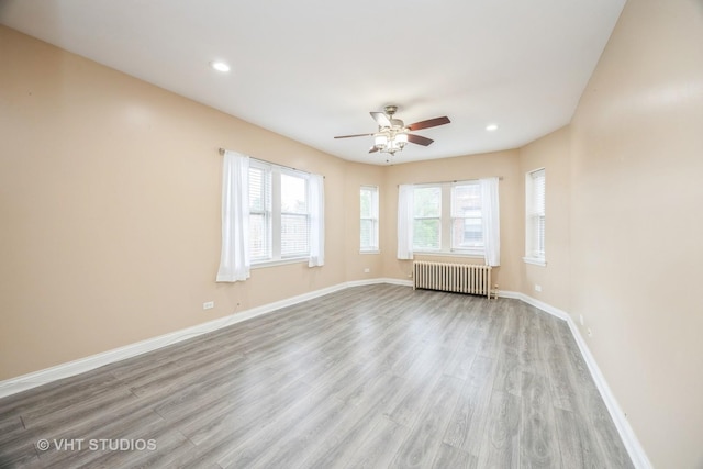 50 Forest Ave Unit 3S, Riverside, IL 60546 - empty room featuring radiator, wood finished floors, a ceiling fan, baseboards, and recessed lighting
