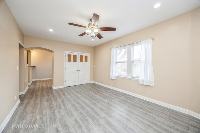 50 Forest Ave Unit 3S, Riverside, IL 60546 - unfurnished bedroom with arched walkways, light wood-style flooring, baseboards, recessed lighting, and a closet