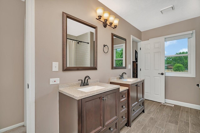 3513 Harris Dr, Joliet, IL 60431 - bathroom with healthy amount of natural light, two vanities, and baseboards