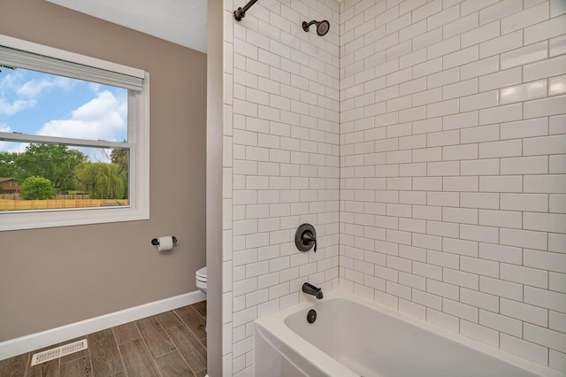 3513 Harris Dr, Joliet, IL 60431 - full bath featuring toilet, baseboards, wood tiled floors, and  shower combination