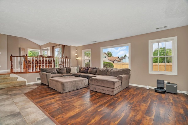 3513 Harris Dr, Joliet, IL 60431 - living room featuring stairs, baseboards, wood finished floors, lofted ceiling, and a textured ceiling