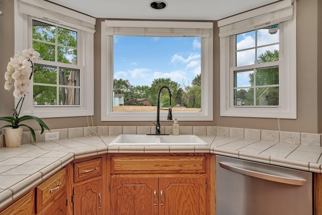 3513 Harris Dr, Joliet, IL 60431 - kitchen featuring stainless steel dishwasher, a sink, and brown cabinetry