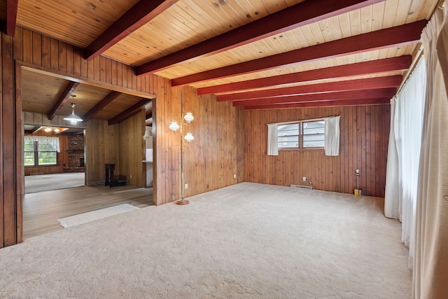 214 Hickory Ln, Momence, IL 60954 - empty room with carpet flooring, healthy amount of natural light, wood walls, and a wooden ceiling with exposed beams
