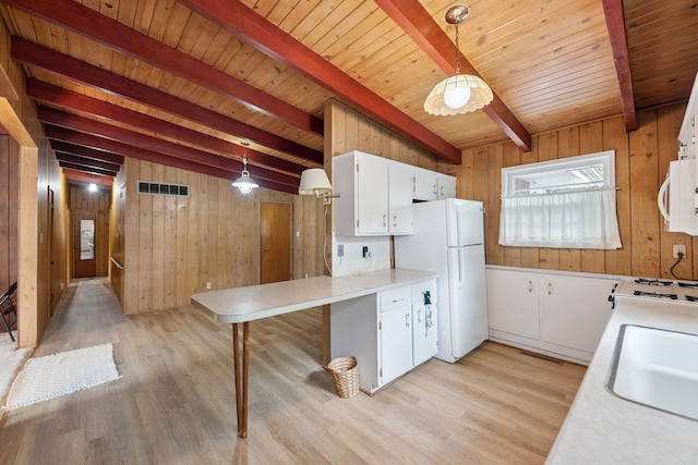 214 Hickory Ln, Momence, IL 60954 - kitchen featuring white appliances, wooden walls, light wood finished floors, a wood ceiling with exposed beams, and light countertops