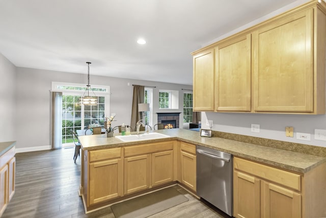 2451 Stonegate Rd Unit 2451, Algonquin, IL 60102 - kitchen with stainless steel dishwasher, a sink, light brown cabinetry, a peninsula, and wood finished floors