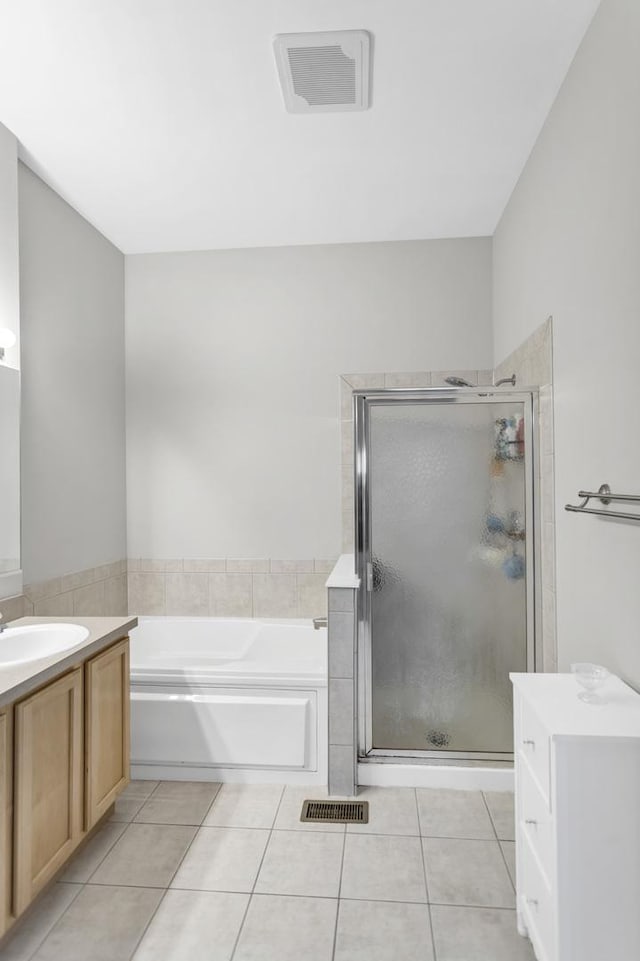 2451 Stonegate Rd Unit 2451, Algonquin, IL 60102 - bathroom featuring a garden tub, a shower stall, tile patterned flooring, and vanity