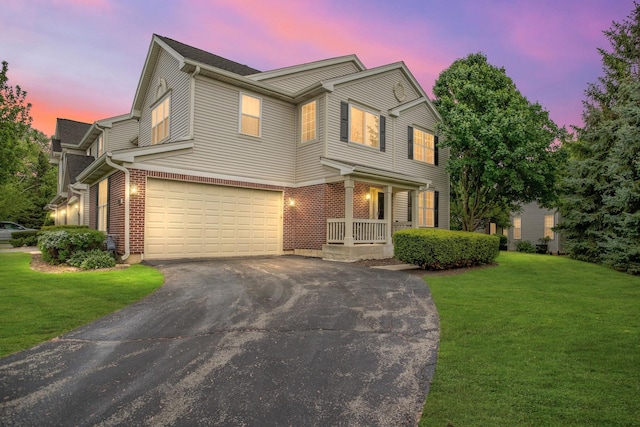 2451 Stonegate Rd Unit 2451, Algonquin, IL 60102 - traditional-style house with asphalt driveway, a yard, a garage, and a porch