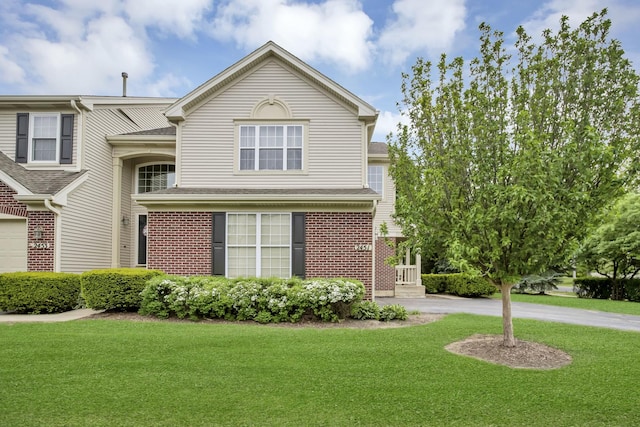 2451 Stonegate Rd Unit 2451, Algonquin, IL 60102 - traditional home featuring a front yard, brick siding, and a shingled roof