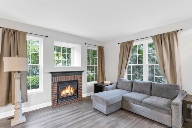 2451 Stonegate Rd Unit 2451, Algonquin, IL 60102 - living room featuring a brick fireplace, wood finished floors, and baseboards