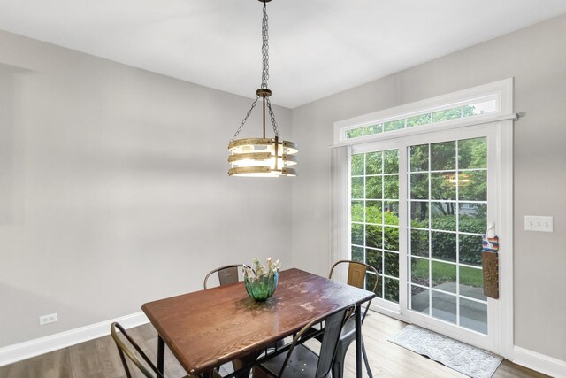 2451 Stonegate Rd Unit 2451, Algonquin, IL 60102 - dining space featuring baseboards, wood finished floors, and a chandelier