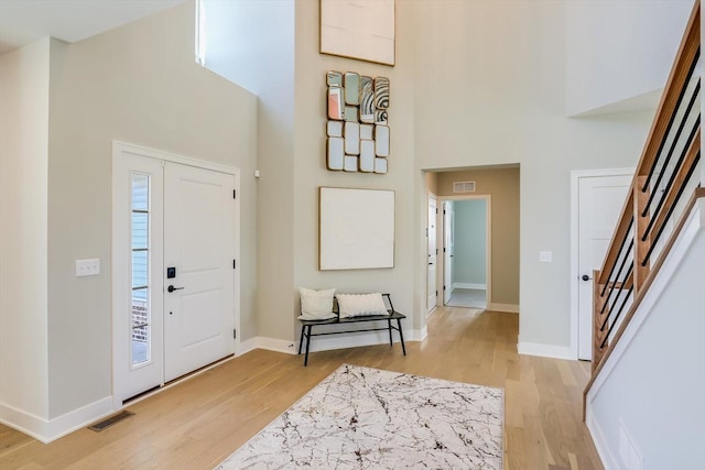 23244 W Teton Ln, Plainfield, IL 60585 - foyer featuring a high ceiling, light wood-style flooring, baseboards, and stairs