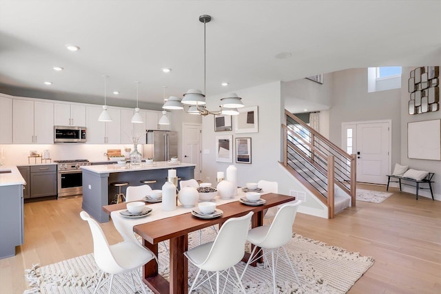 23244 W Teton Ln, Plainfield, IL 60585 - dining space featuring stairway, light wood-type flooring, a chandelier, recessed lighting, and a high ceiling