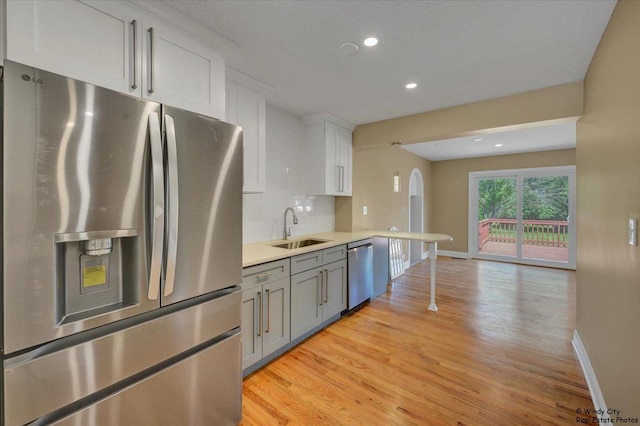 215 S Forest Ave, Palatine, IL 60074 - kitchen featuring appliances with stainless steel finishes, a sink, baseboards, light wood-style flooring, and recessed lighting