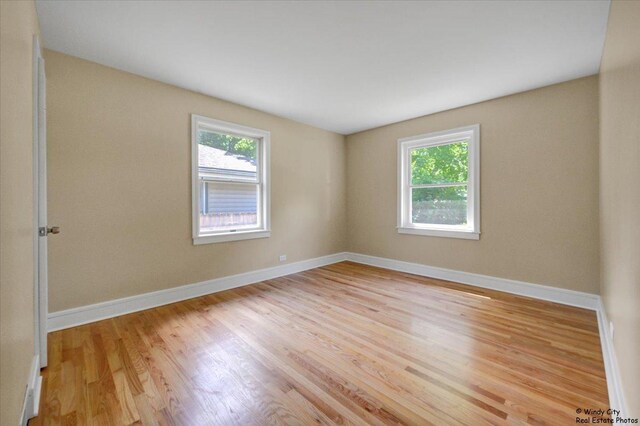 215 S Forest Ave, Palatine, IL 60074 - spare room with plenty of natural light, wood finished floors, and baseboards