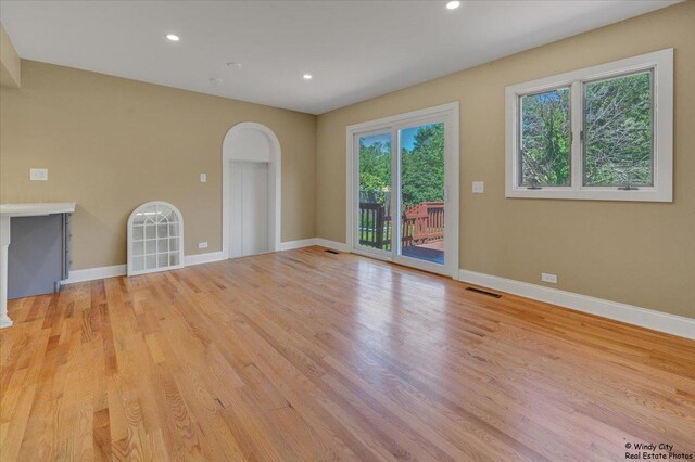 215 S Forest Ave, Palatine, IL 60074 - empty room with light wood finished floors, arched walkways, baseboards, and recessed lighting