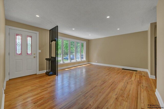 215 S Forest Ave, Palatine, IL 60074 - entrance foyer featuring a textured ceiling, baseboards, light wood finished floors, and recessed lighting