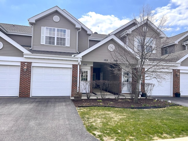 1715 White Oak Trl Unit C1, Cherry Valley, IL 61016 - view of front of house featuring brick siding, driveway, roof with shingles, and a garage