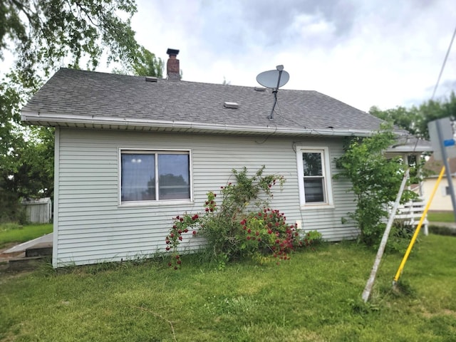1211 S Clayton St, Bloomington, IL 61701 - rear view of house featuring roof with shingles and a chimney