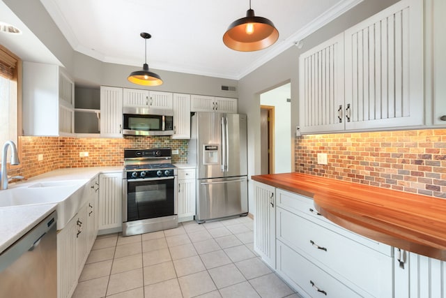 100 N Gary Ave N Unit 304, Wheaton, IL 60187 - kitchen with appliances with stainless steel finishes, open shelves, butcher block countertops, decorative backsplash, and light tile patterned floors