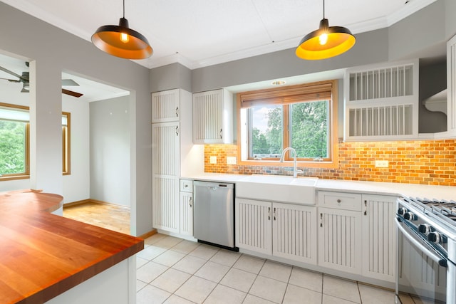 100 N Gary Ave N Unit 304, Wheaton, IL 60187 - kitchen featuring stainless steel appliances, plenty of natural light, decorative backsplash, light tile patterned floors, and crown molding