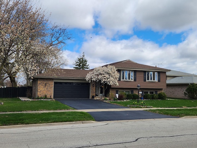 1016 W Willow Ln, Mount Prospect, IL 60056 - split level home featuring an attached garage, driveway, and brick siding