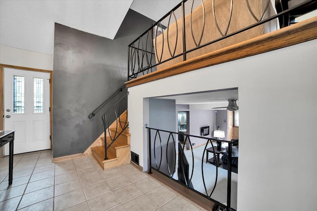 1016 W Willow Ln, Mount Prospect, IL 60056 - tiled foyer entrance with stairway, a towering ceiling, baseboards, and ceiling fan