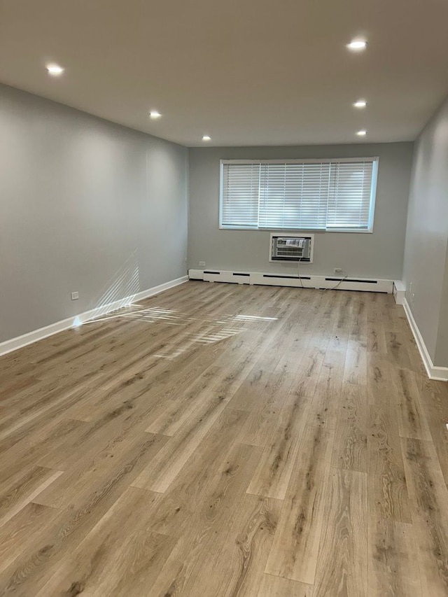 8521 Lotus Ave Unit 706, Skokie, IL 60077 - unfurnished room featuring recessed lighting, wood finished floors, a wall mounted air conditioner, and baseboards