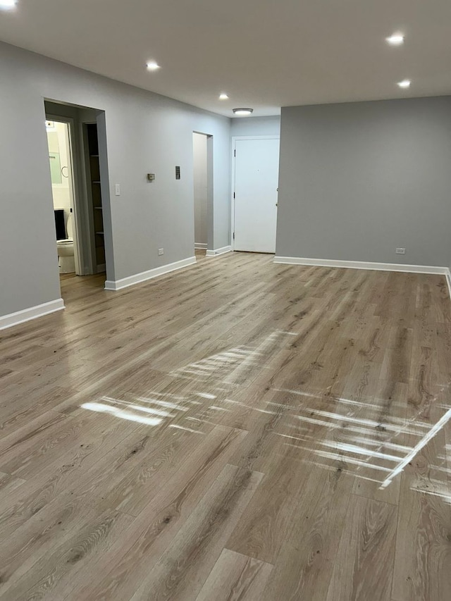 8521 Lotus Ave Unit 706, Skokie, IL 60077 - unfurnished living room with light wood finished floors, recessed lighting, and baseboards
