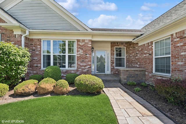 13881 Traverse Ct, Huntley, IL 60142 - view of exterior entry featuring brick siding and roof with shingles