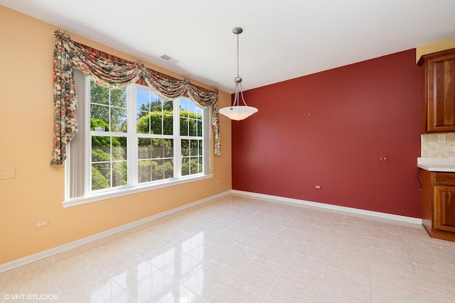 13881 Traverse Ct, Huntley, IL 60142 - unfurnished dining area with healthy amount of natural light, baseboards, and light tile patterned floors