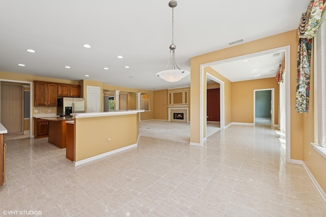 13881 Traverse Ct, Huntley, IL 60142 - kitchen with stainless steel fridge with ice dispenser, recessed lighting, open floor plan, light tile patterned floors, and a center island