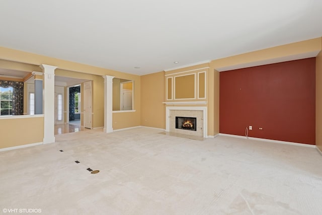 13881 Traverse Ct, Huntley, IL 60142 - unfurnished living room with baseboards, decorative columns, a fireplace with flush hearth, and light carpet