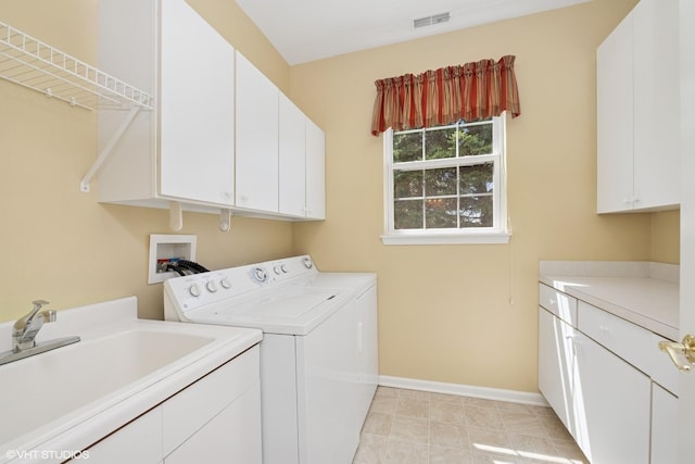 13881 Traverse Ct, Huntley, IL 60142 - clothes washing area with cabinet space, washing machine and dryer, baseboards, and light tile patterned floors