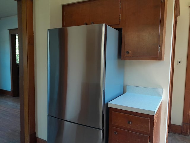 516 S Grant St, Earlville, IL 60518 - kitchen with freestanding refrigerator, light countertops, and brown cabinetry